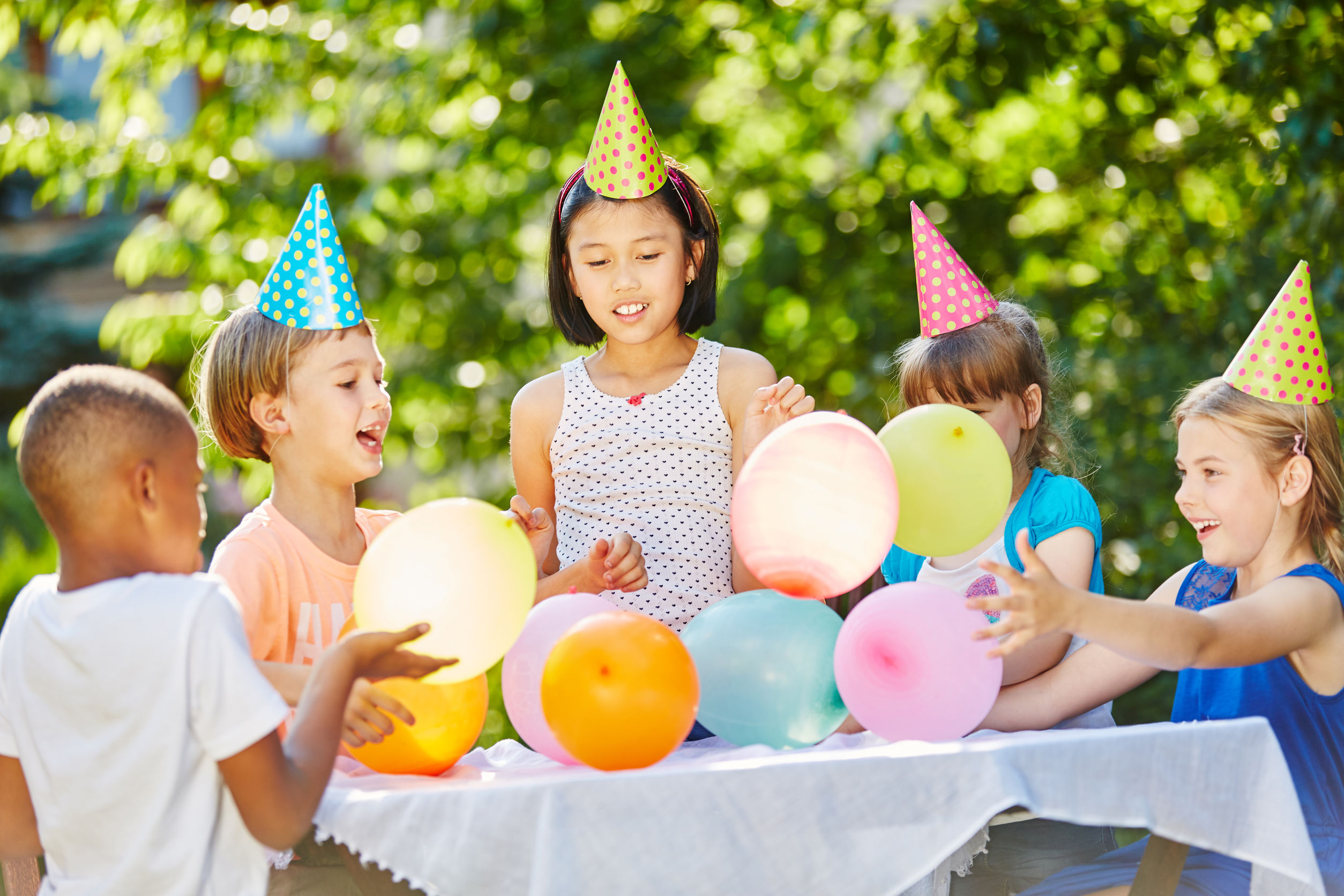 71633955 – many kids celebrate birthday together with balloons and party hats