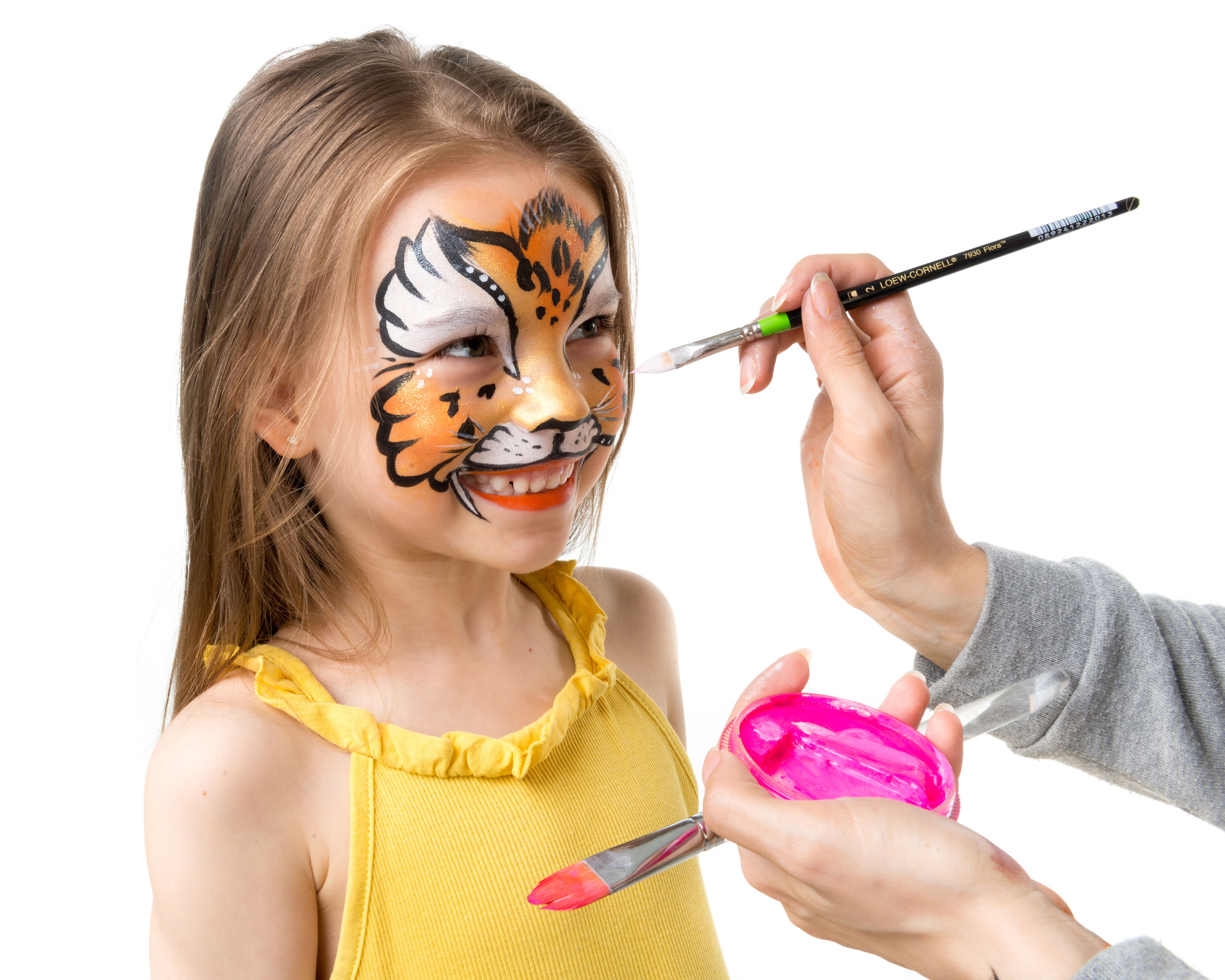 66160250 – joyful little girl getting her face painted like tiger by artist